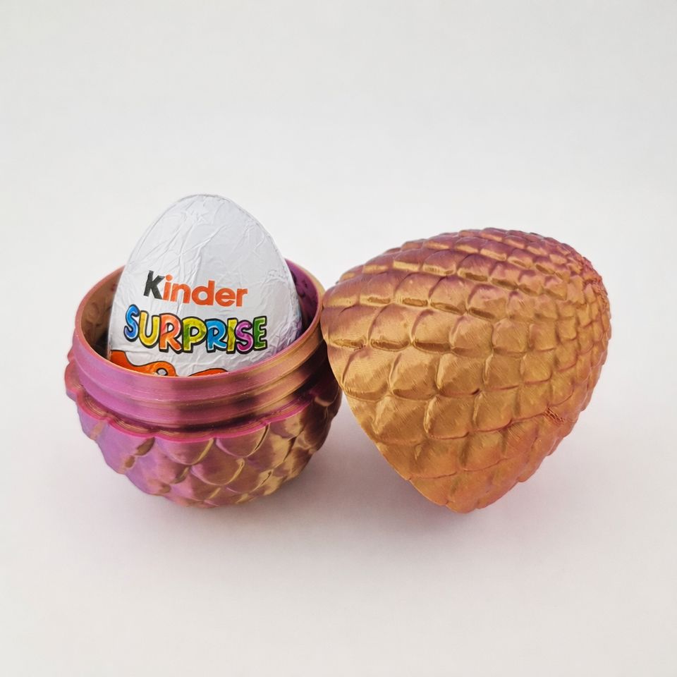 Gyldent og lilla drageæg med skælstruktur, åbnet med Kinder Surprise-æg.
