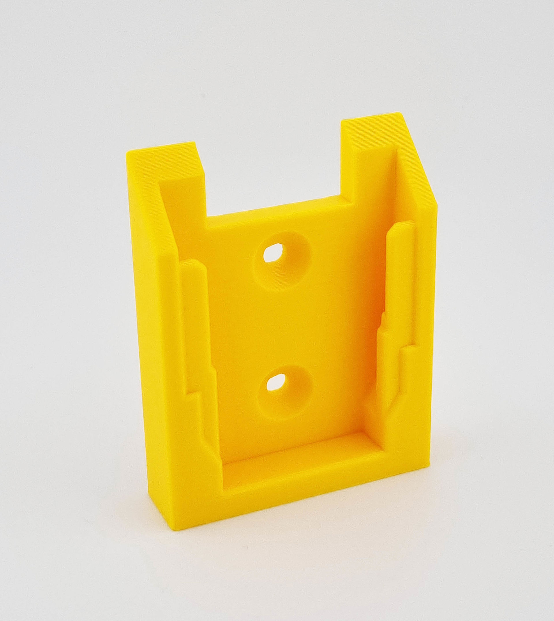 Gul 3D-printet værktøjsholder med to skruehuller og åbne skinner